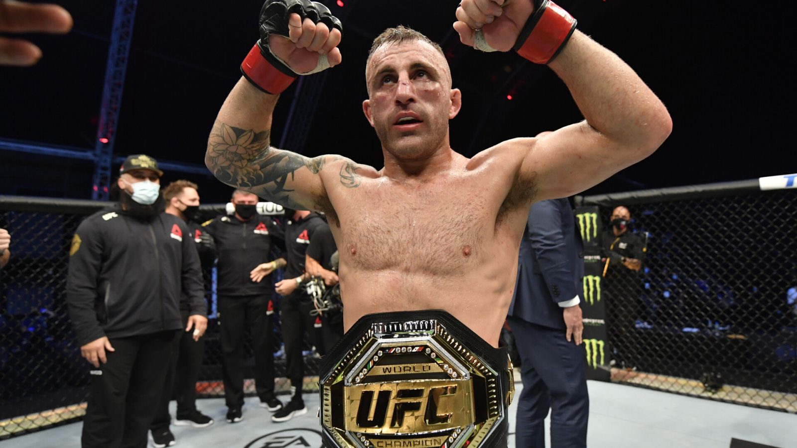 UFC featherweight champion Alexander Volkanovski shows off his title belt.