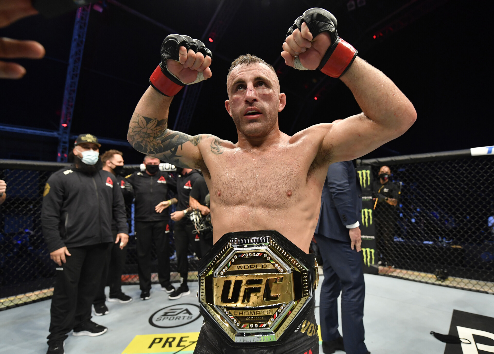 UFC featherweight champion Alexander Volkanovski shows off his title belt.