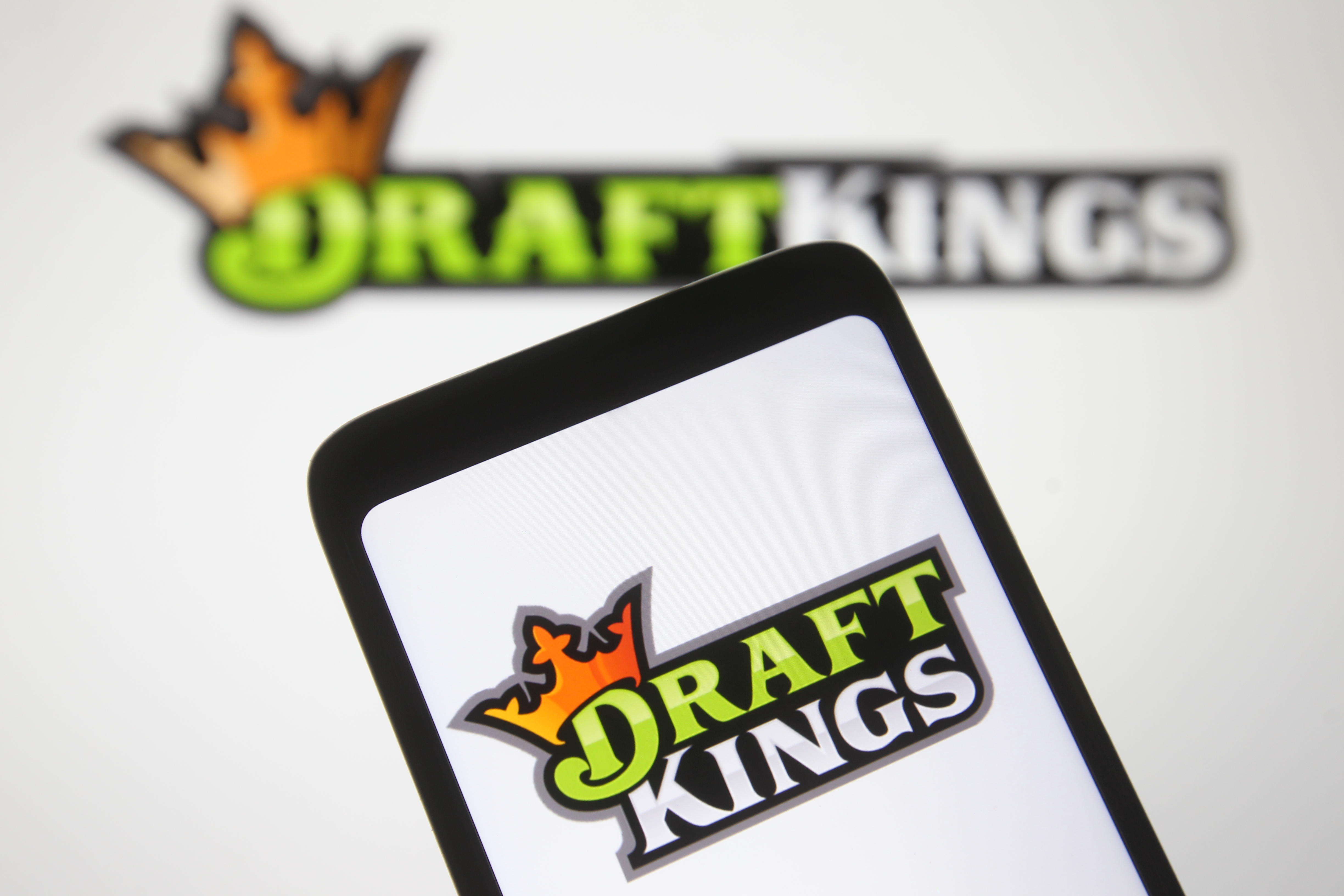 In this photo illustration a DraftKings logo, of the U.S. daily fantasy sports contest and sports betting operator, is seen on a mobile phone screen