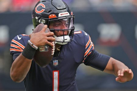 Chicago Bears QB #1 Justin Fields runs the ball in a 2021 home game at Soldier Field in Chicago, IL.