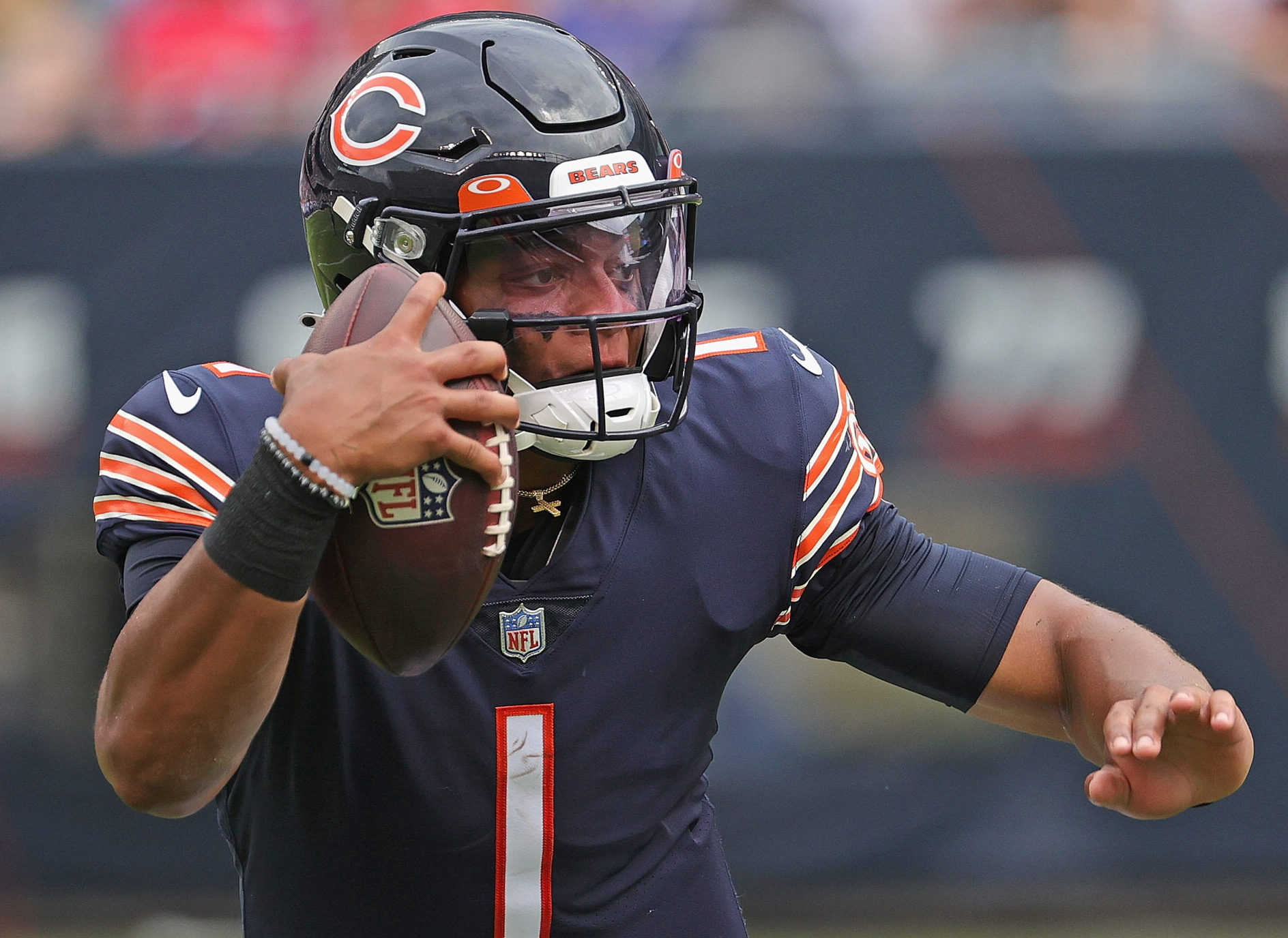 Chicago Bears QB #1 Justin Fields runs the ball in a 2021 home game at Soldier Field in Chicago, IL.