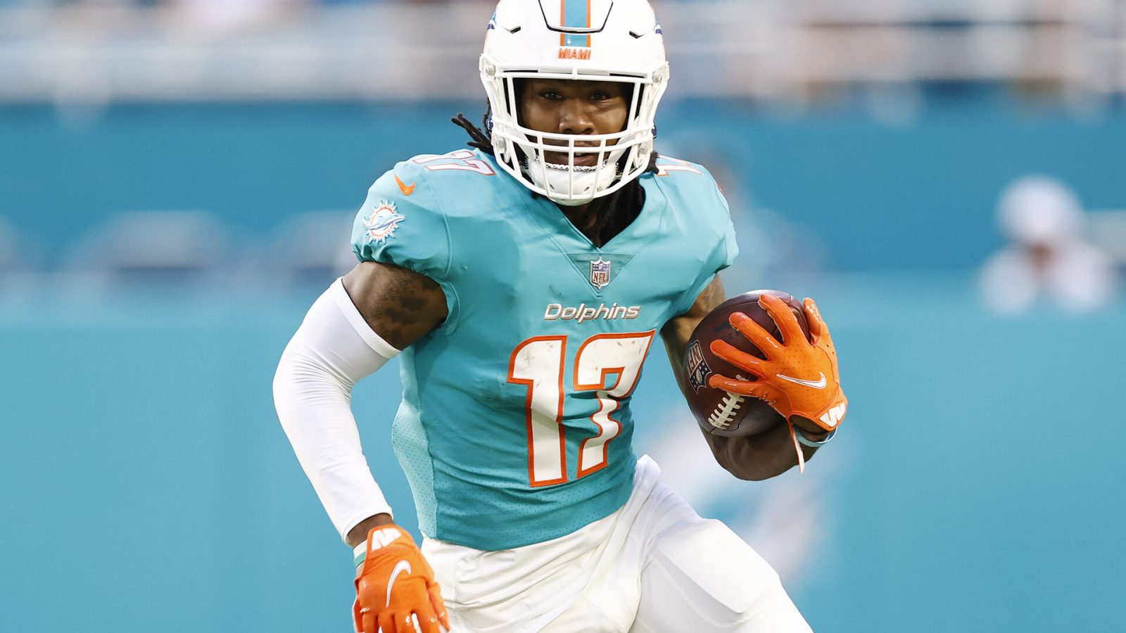 Miami Dolphins wide receiver #17 Jaylen Waddle runs with the ball in a 2021 home game.