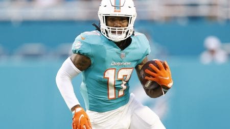 Miami Dolphins wide receiver #17 Jaylen Waddle runs with the ball in a 2021 home game.