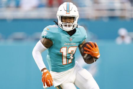 Miami Dolphins wide receiver #17 Jaylen Waddle runs with the ball in a 2021 home game.