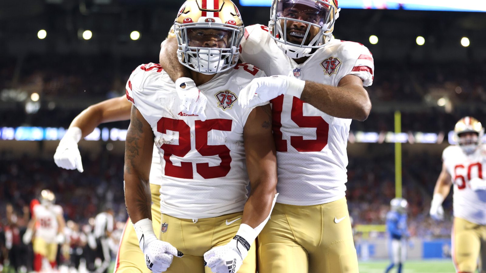 San Francisco 49ers defensive back Elijah Mitchell celebrates with a teammate after an interception