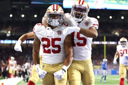San Francisco 49ers defensive back Elijah Mitchell celebrates with a teammate after an interception