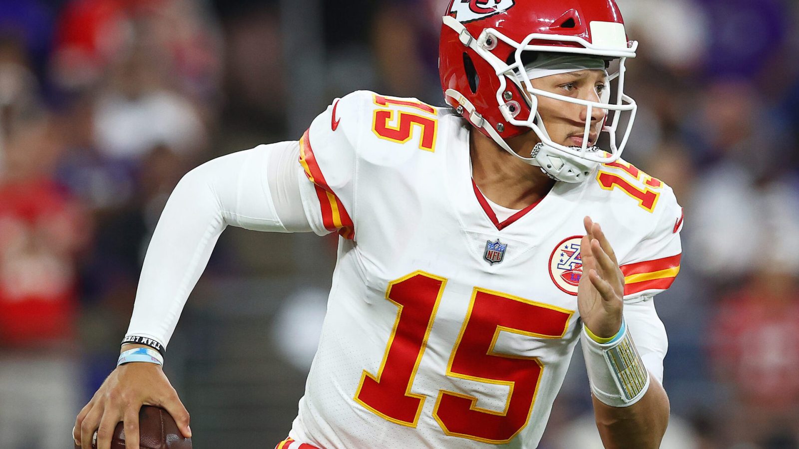 Kansas City quarterback #15 Patrick Mahomes scrambles in a 2021 road game.