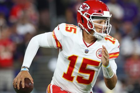 Kansas City quarterback #15 Patrick Mahomes scrambles in a 2021 road game.