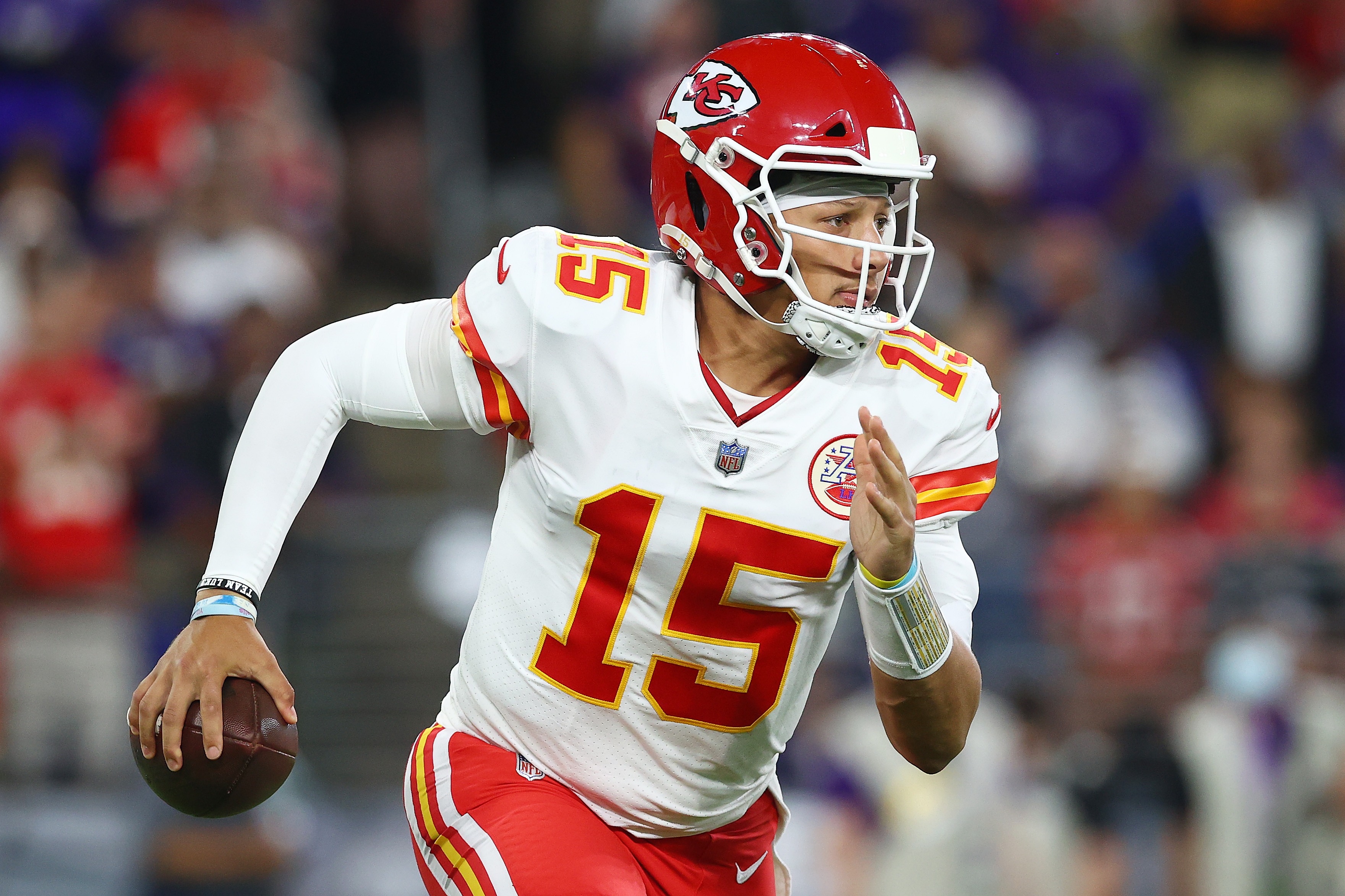 Kansas City quarterback #15 Patrick Mahomes scrambles in a 2021 road game.