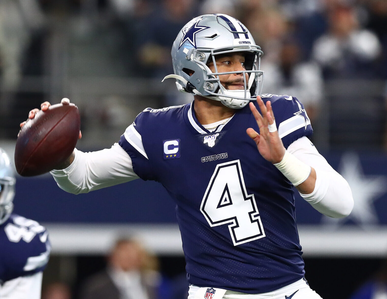 Dallas Cowboys quarterback #4 Dak Prescott looks downfield in a 2020 home game.