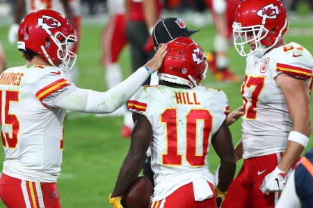 Kansas City Chiefs teammates Patrick Mahomes, Tyreek Hill and Travis Kelce celebrate during a 2021-22 regular-season game.