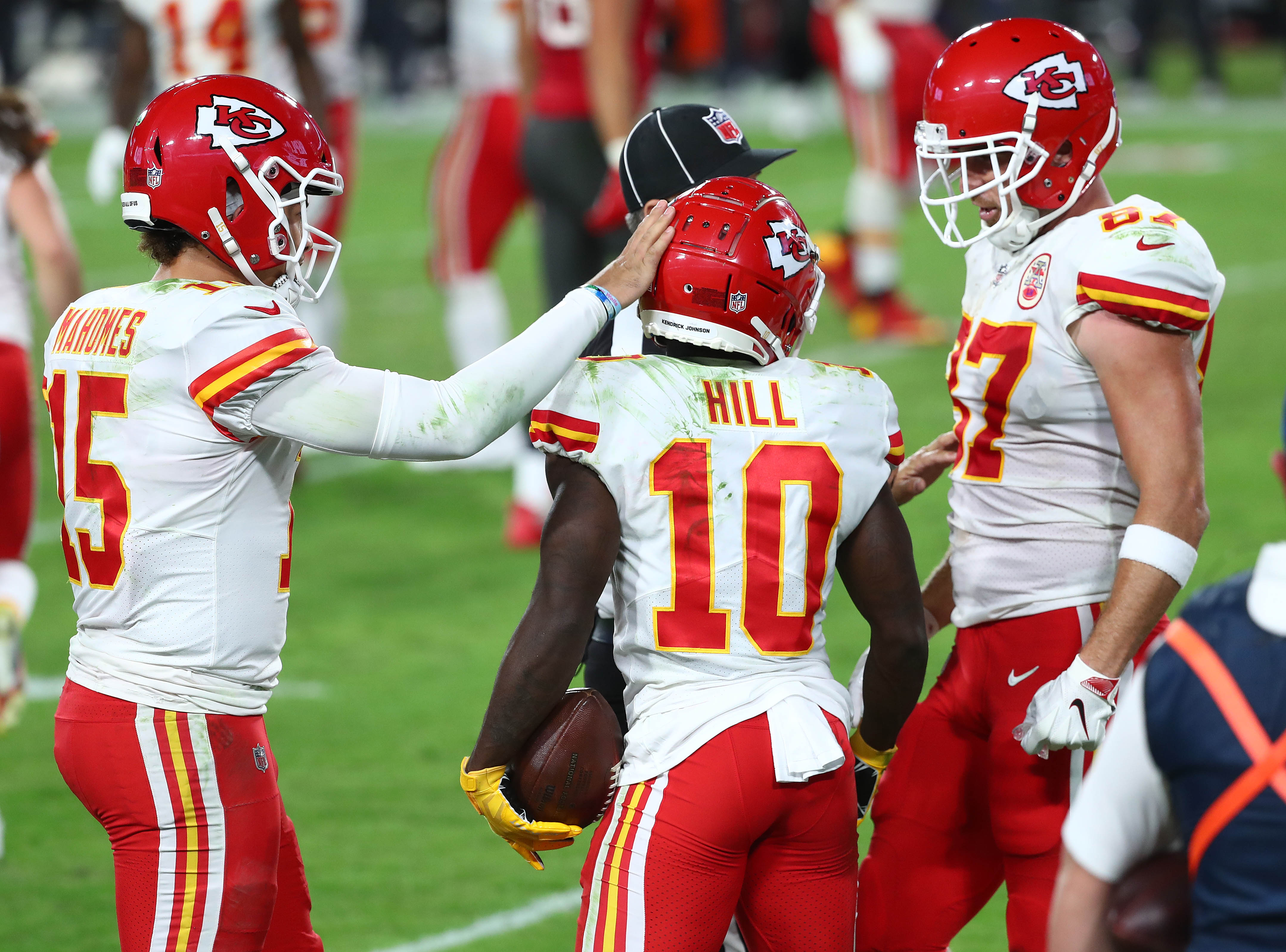 Kansas City Chiefs teammates Patrick Mahomes, Tyreek Hill and Travis Kelce celebrate during a 2021-22 regular-season game.