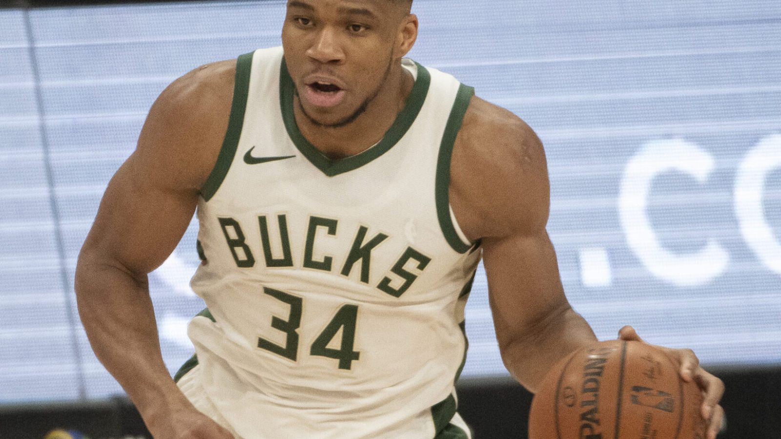 Milwaukee Bucks forward #34 Giannis Antetonkoumpo brings the ball up the court in a 2020 home game.