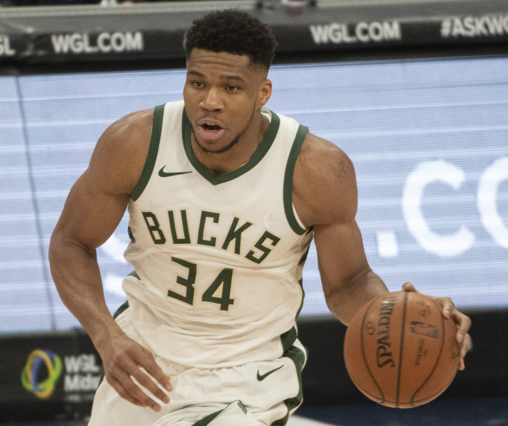 Milwaukee Bucks forward #34 Giannis Antetonkoumpo brings the ball up the court in a 2020 home game.