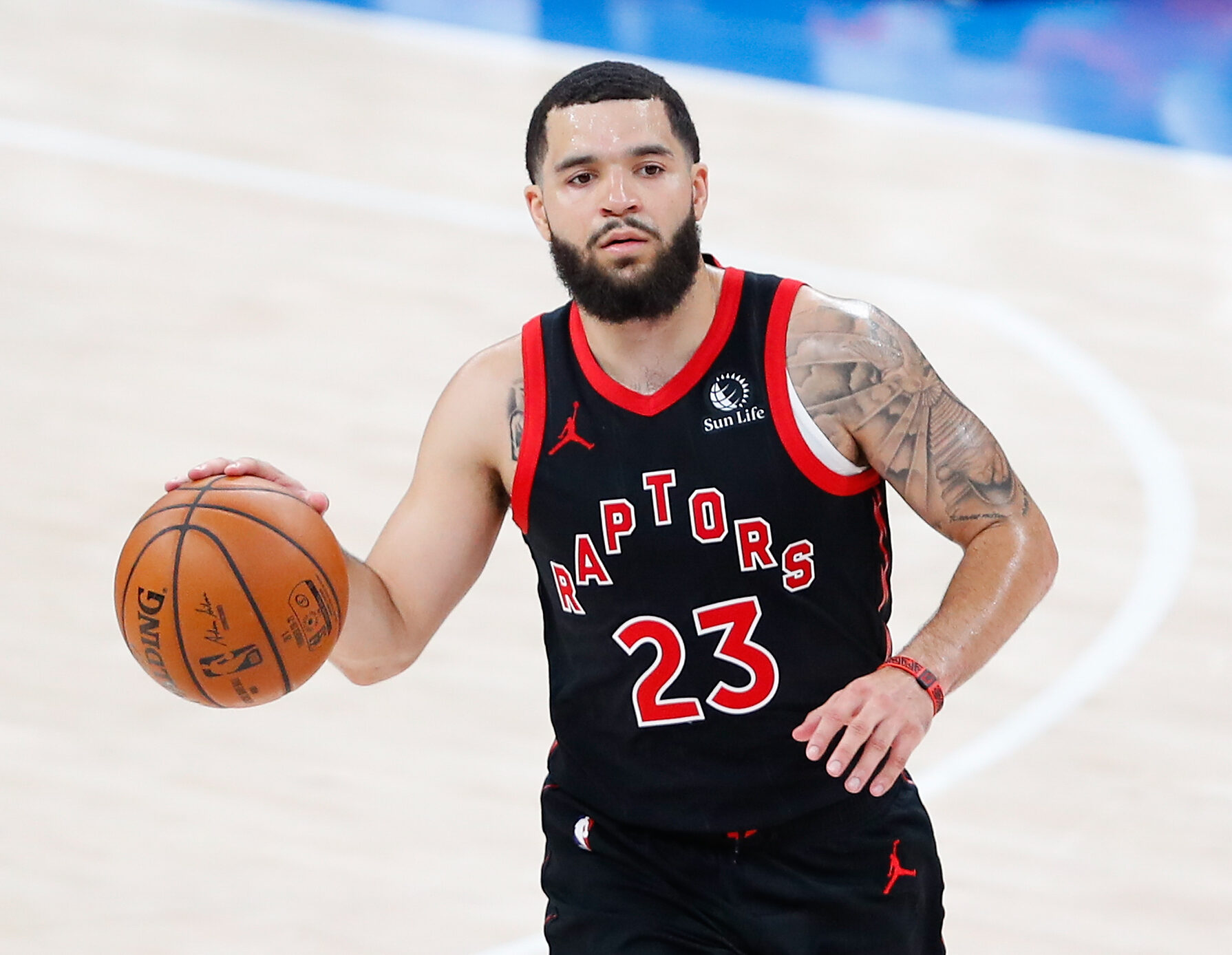 Toronto Raptors guard #23 Fred VanVleet brings the ball up the court in a 2021 game.