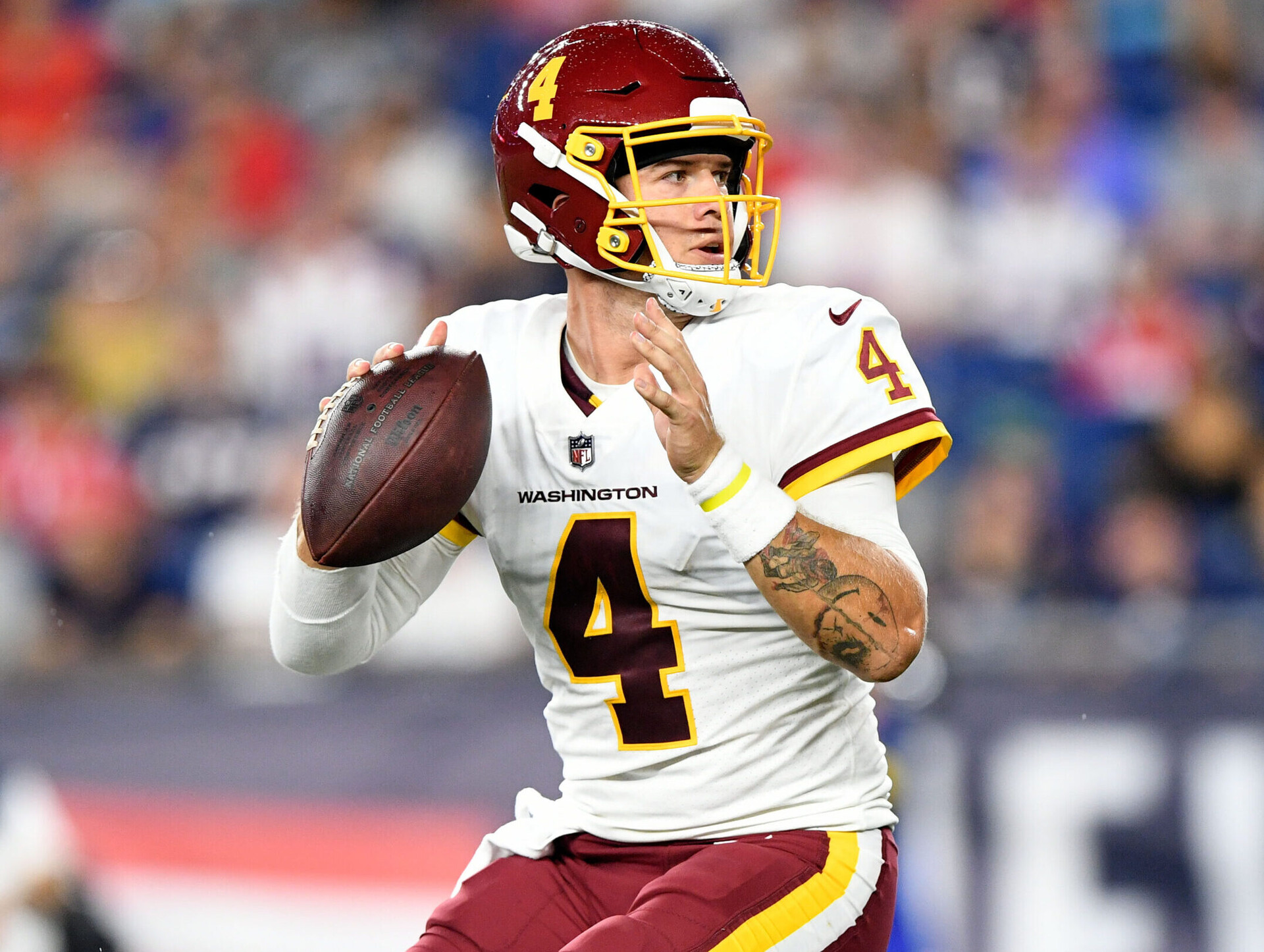 Washington Football Team quarterback Taylor Heinicke looks to pass the ball down field in a game against the New England Patriots