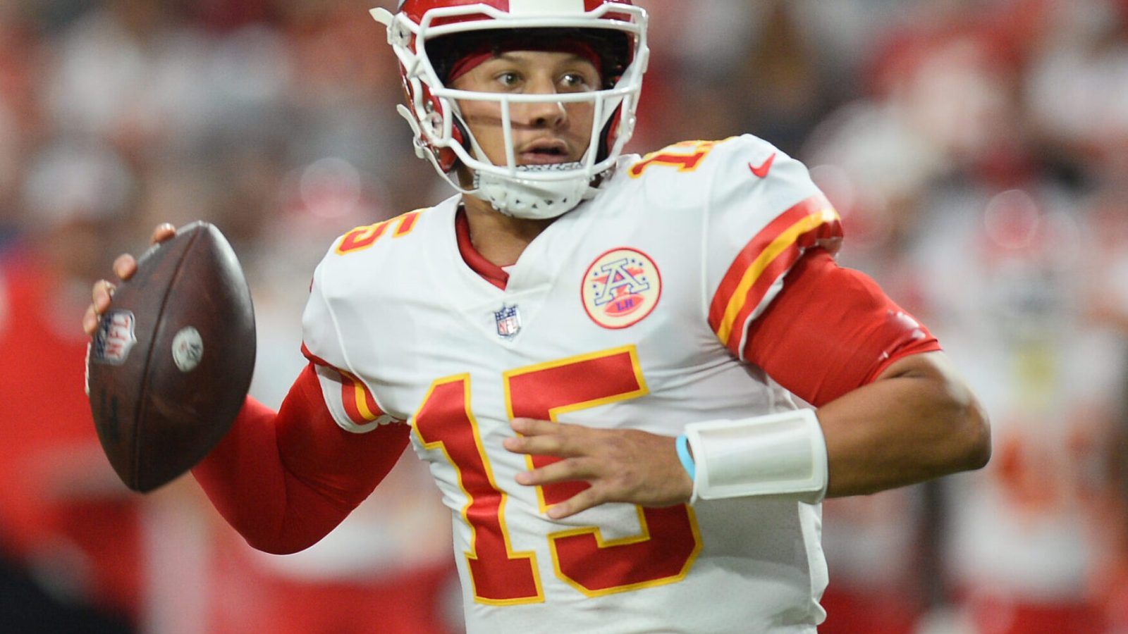Kansas City Chiefs quarterback Patrick Mahomes rolls out looking to throw the ball