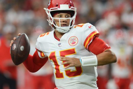 Kansas City Chiefs quarterback Patrick Mahomes rolls out looking to throw the ball