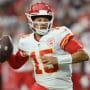 Kansas City Chiefs quarterback Patrick Mahomes rolls out looking to throw the ball