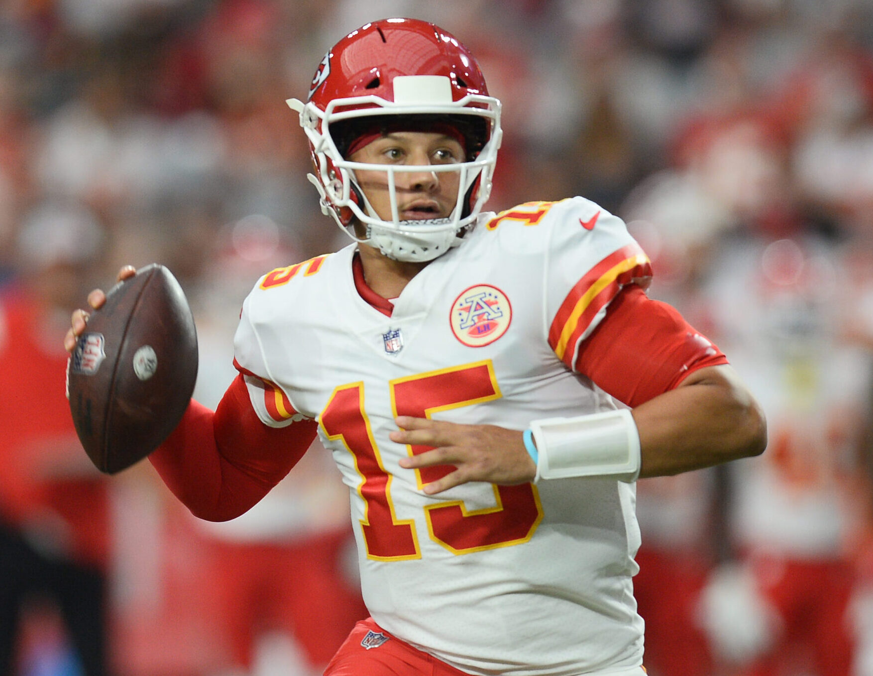 Kansas City Chiefs quarterback Patrick Mahomes rolls out looking to throw the ball