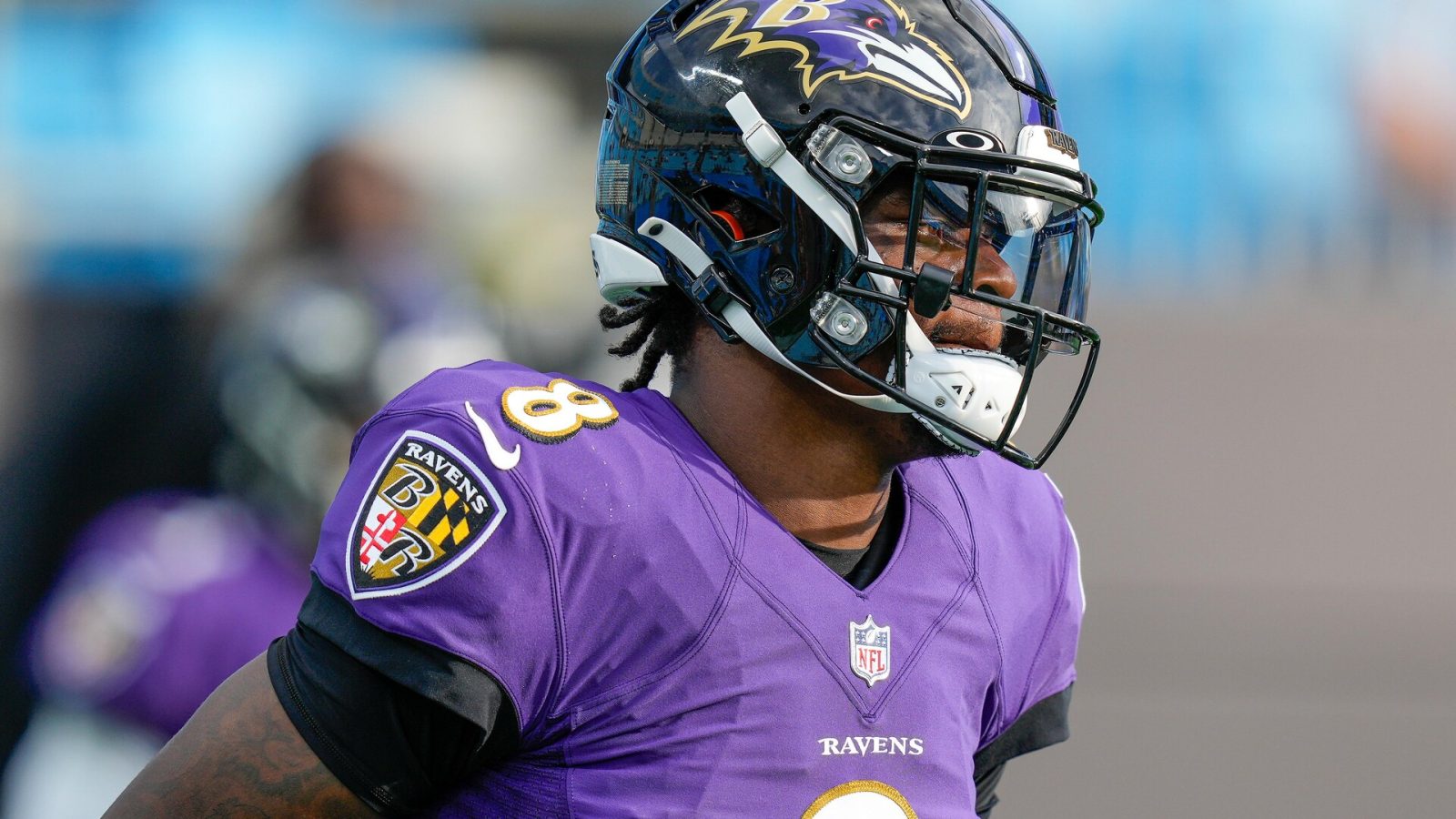 Baltimore Ravens quarterback #8 Lamar Jackson warms up before a 2020 game.