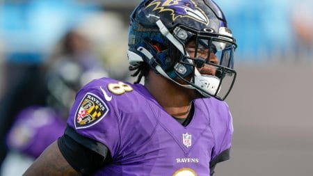 Baltimore Ravens quarterback #8 Lamar Jackson warms up before a 2020 game.