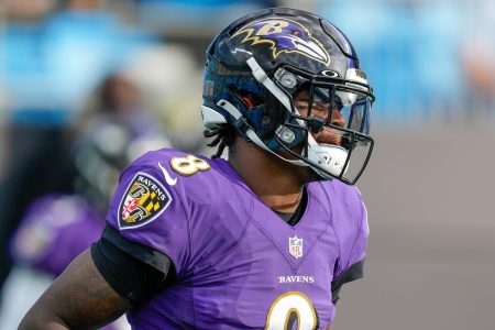 Baltimore Ravens quarterback #8 Lamar Jackson warms up before a 2020 game.