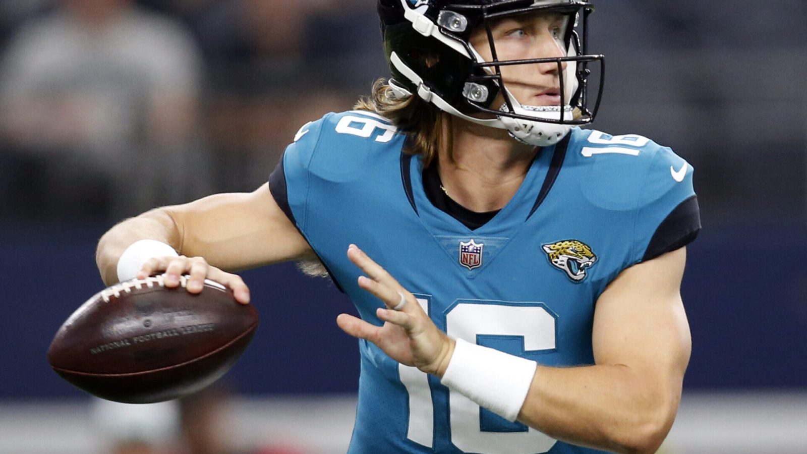 Jacksonville Jaguars quarterback Trevor Lawerence prepares to pass the ball downfield in a game