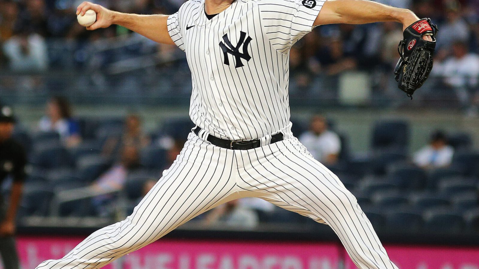 New York Yankees right-handed pitcher Gerrit Cole strides toward the plate while delivering a pitch