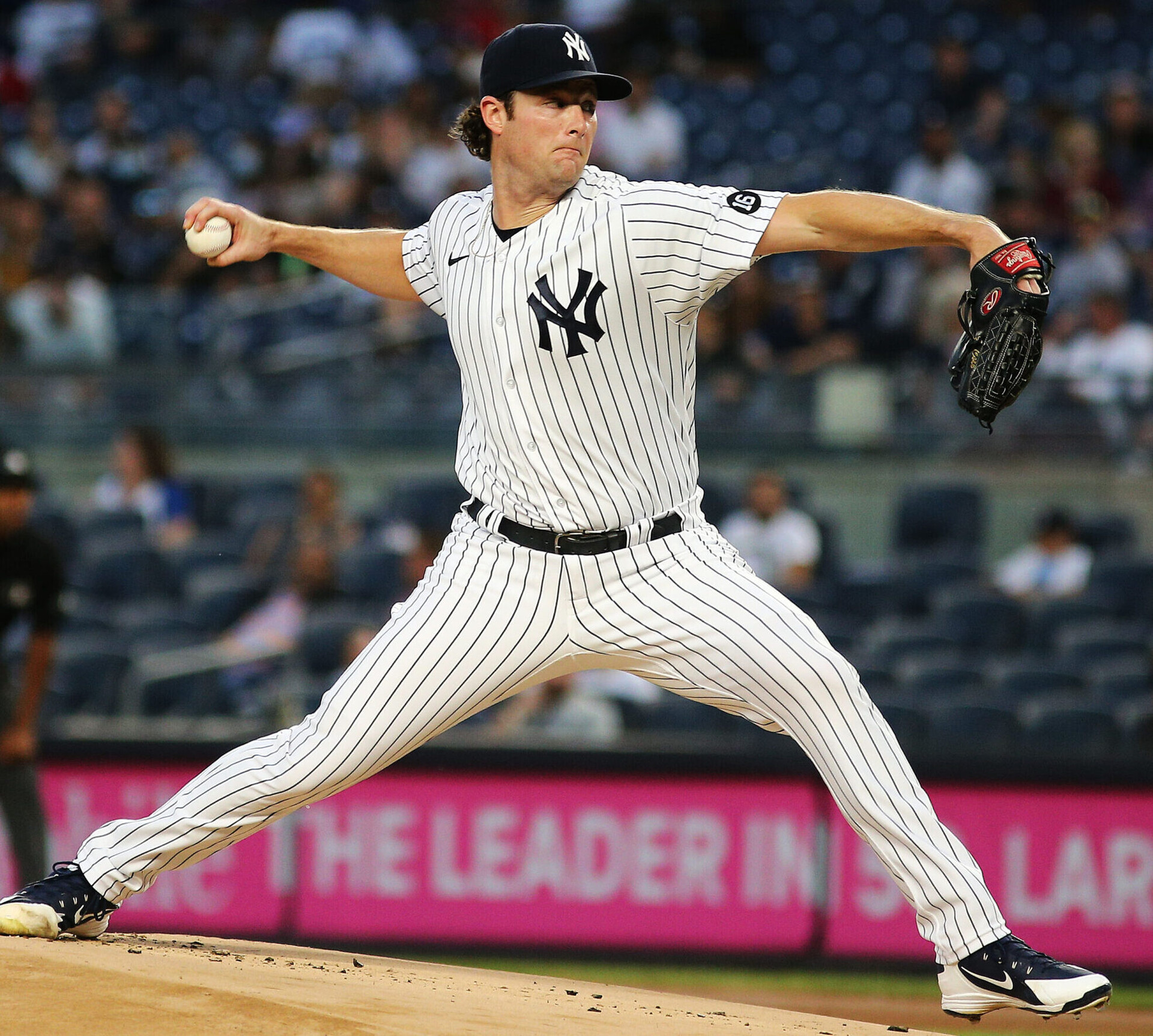 New York Yankees right-handed pitcher Gerrit Cole strides toward the plate while delivering a pitch
