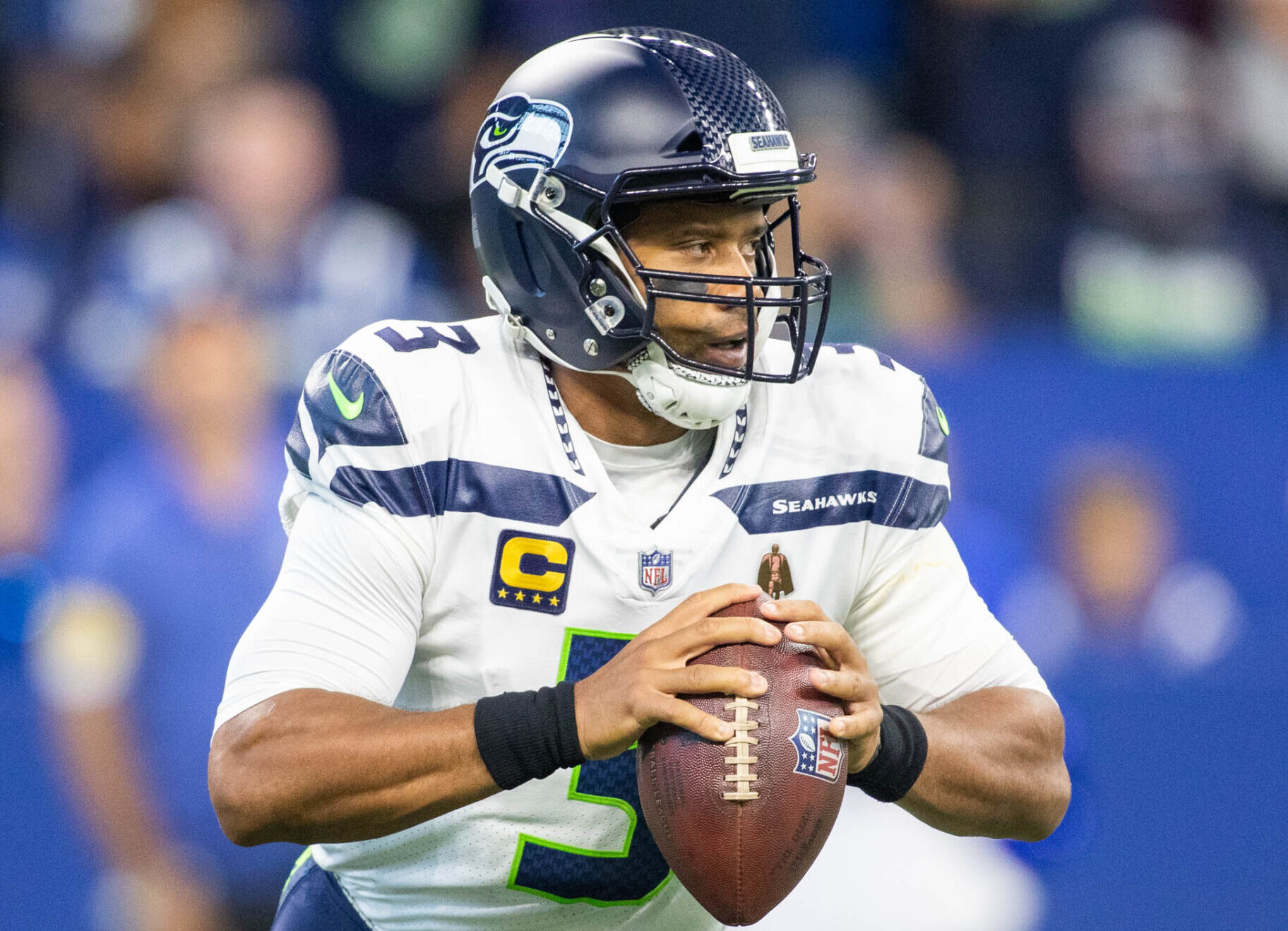 Seattle Seahawks quarterback Russell Wilson holds the football as he looks downfield to pass