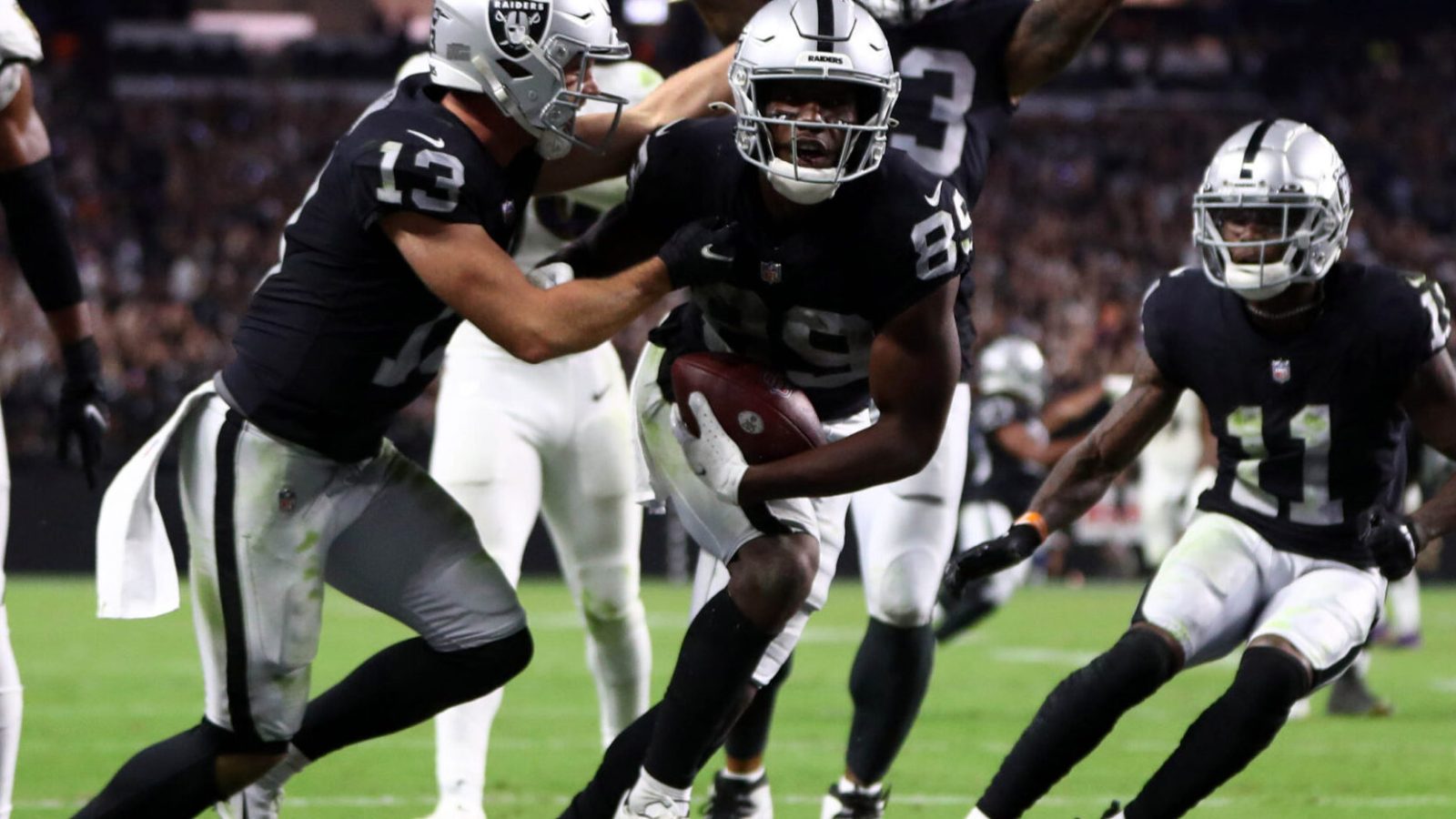 Las Vegas Raiders players celebrate a score during a 2021-22 regular-season game.