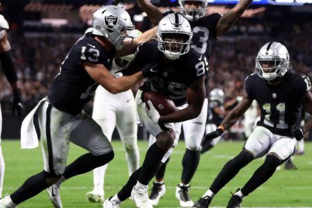 Las Vegas Raiders players celebrate a score during a 2021-22 regular-season game.