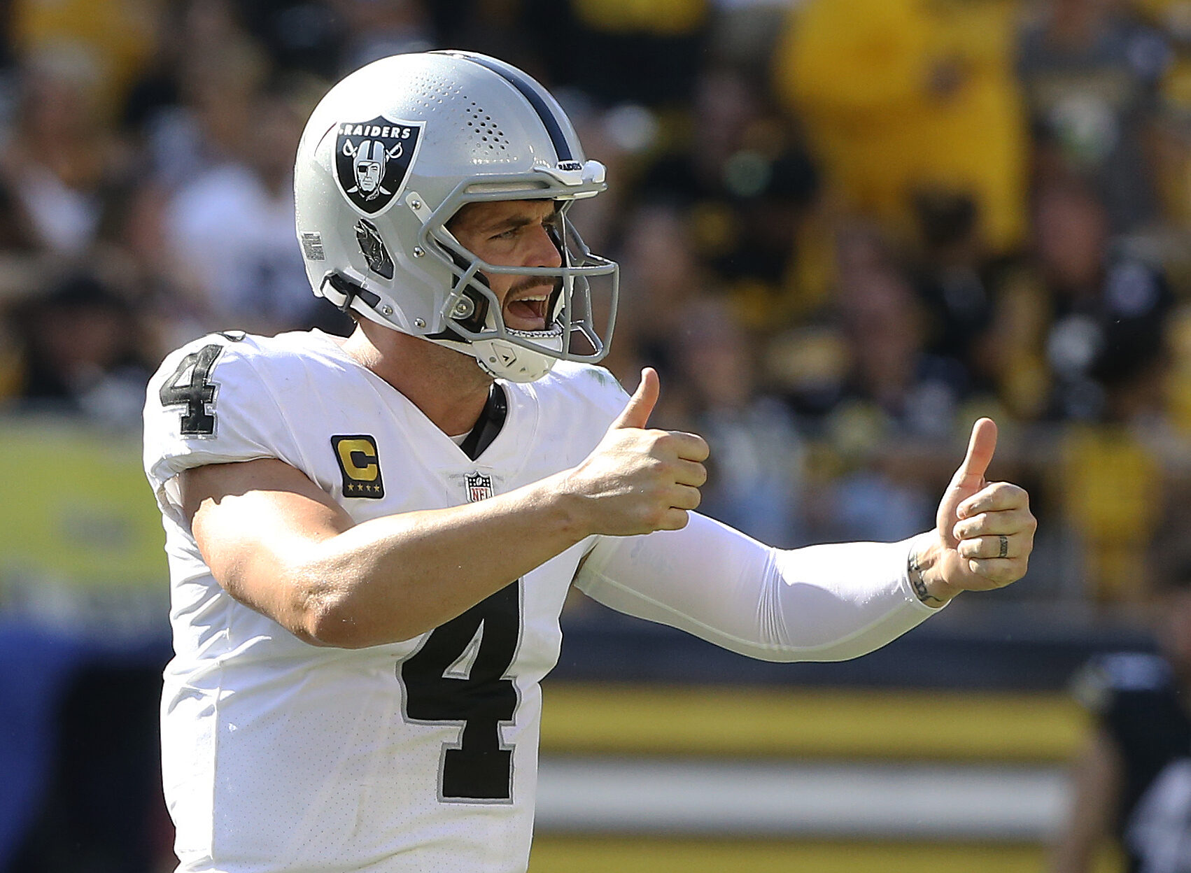 Las Vegas Raiders quarterback Derek Carr signals two thumbs up after making a play against the Pittsburgh Steelers