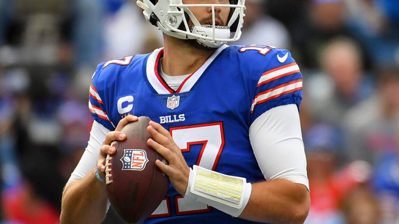 Buffalo Bills QB #17 Josh Allen looks downfield during a pass attempt in a 2021 home game in Buffalo, NY.