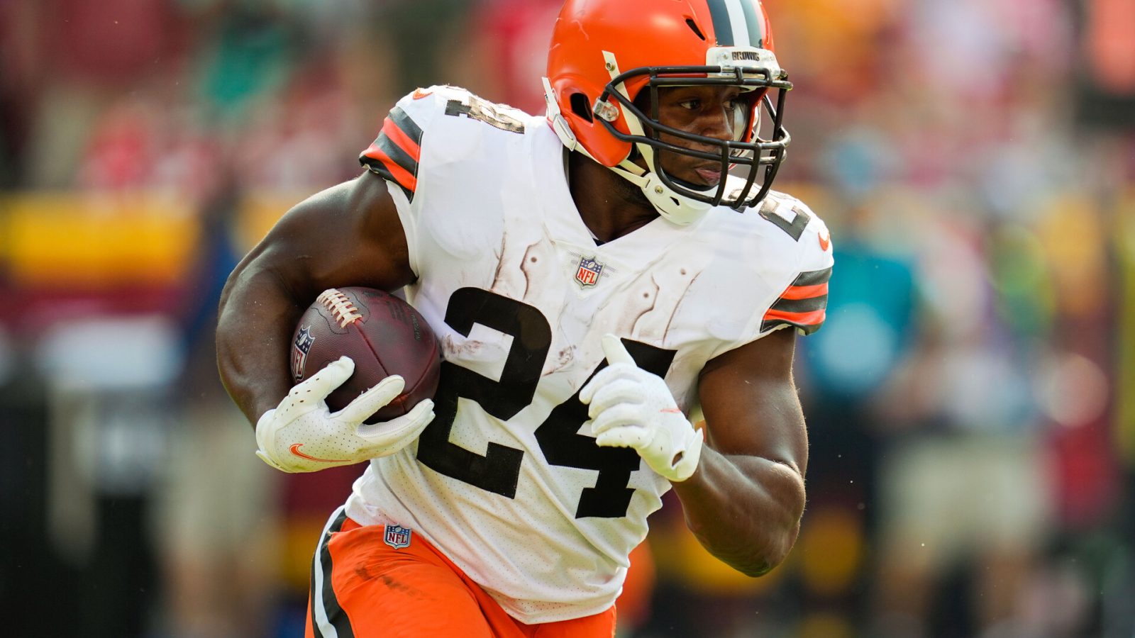 Cleveland Browns running back #24 Nick Chubb runs the ball in a 2021 road game.