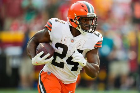 Cleveland Browns running back #24 Nick Chubb runs the ball in a 2021 road game.