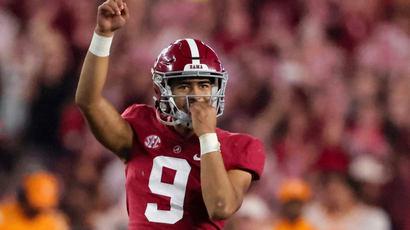 Alabama quarterback Bryce Young raises his right hand and signals "No. 1" after throwing for a touchdown pass
