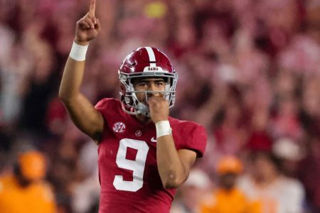 Alabama quarterback Bryce Young raises his right hand and signals "No. 1" after throwing for a touchdown pass
