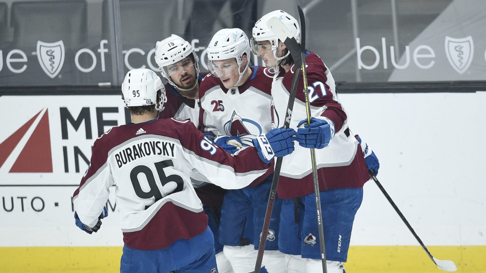Four Colorado Avalanche players celebrate after their team scored a goal