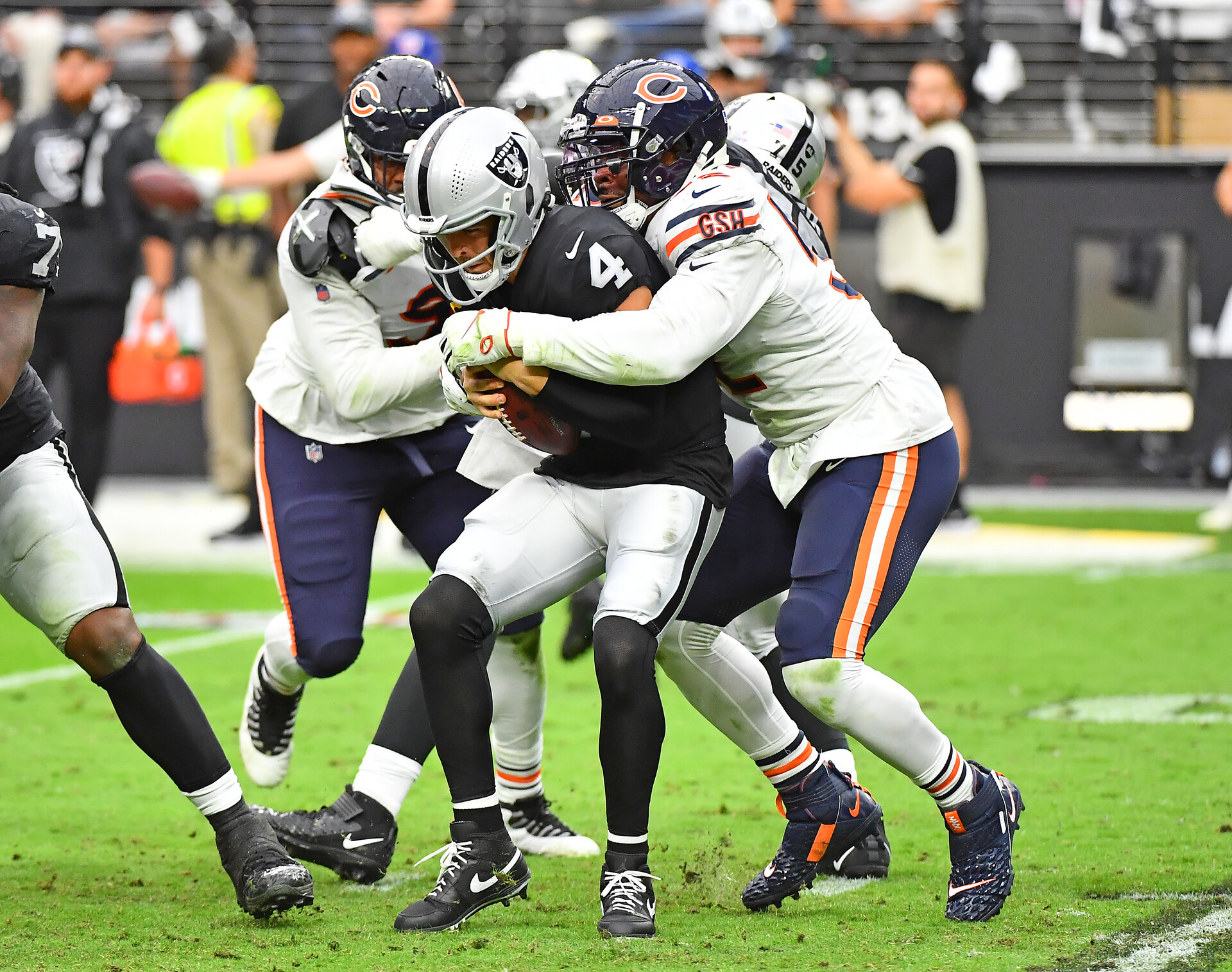 Las Vegas Raiders quarterback Derek Carr is sacked by Chicago Bears outside linebacker Khalil Mack