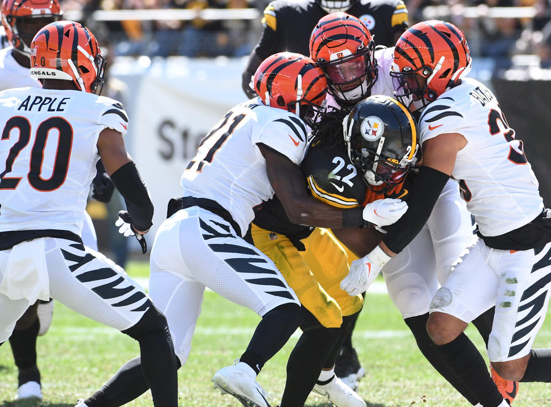 The Cincinnati Bengals defense swarms PITTSBURGH STEELERS running back Najee Harris on a tackle