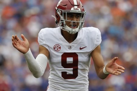 Alabama quarterback Bryce Young claps his hands together at the snap of the football