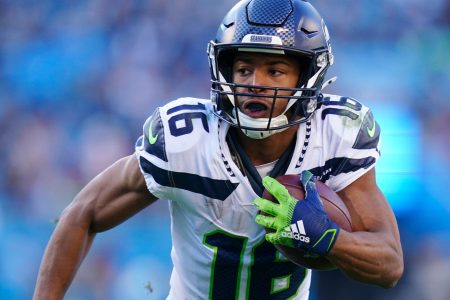 Seattle Seahawks wide receiver Tyler Lockett looks upfield during an NFL game in the 2021 regular season.