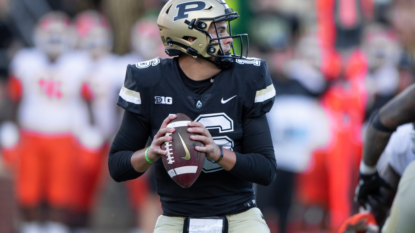 Purdue quarterback Aidan O'Connell #16 looks downfield in a 2021 home game.