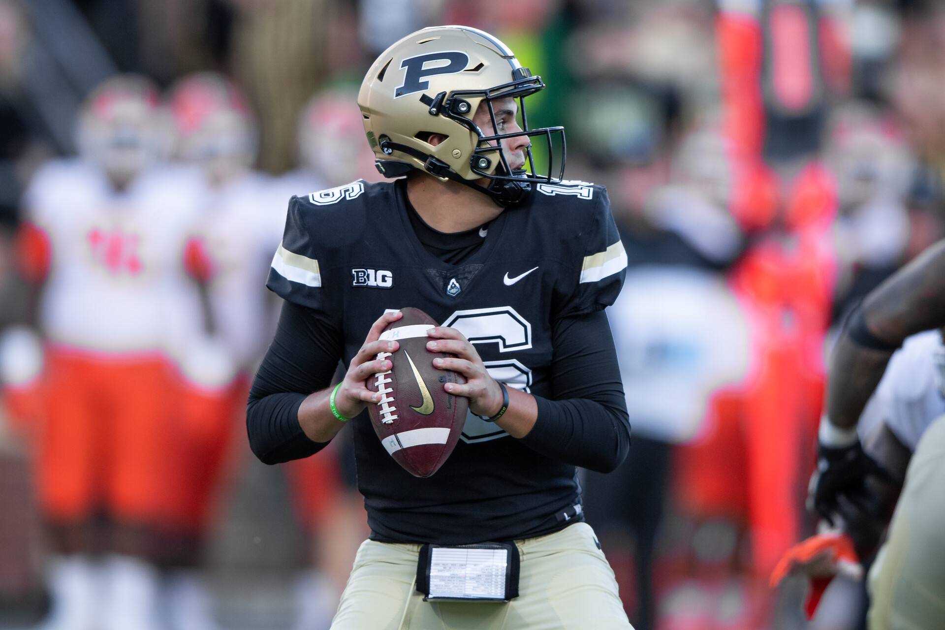 Purdue quarterback Aidan O'Connell #16 looks downfield in a 2021 home game.