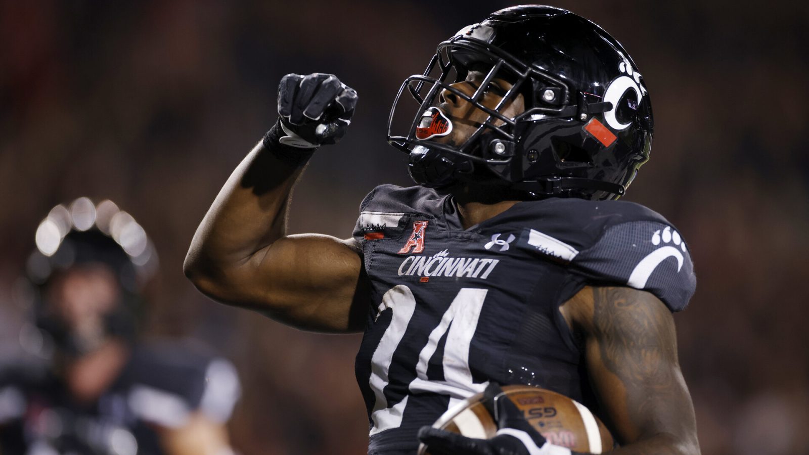 Cincinnati running back #24 Jerome Ford celebrates a touchdown in a 2021 home game.