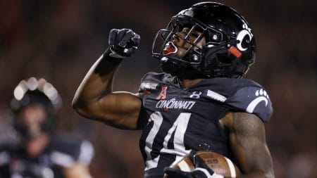 Cincinnati running back #24 Jerome Ford celebrates a touchdown in a 2021 home game.