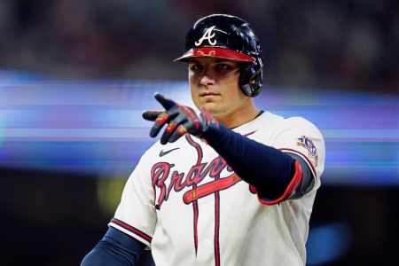 Atlanta Braves third baseman Austin Riley points with his left finger after getting a hit