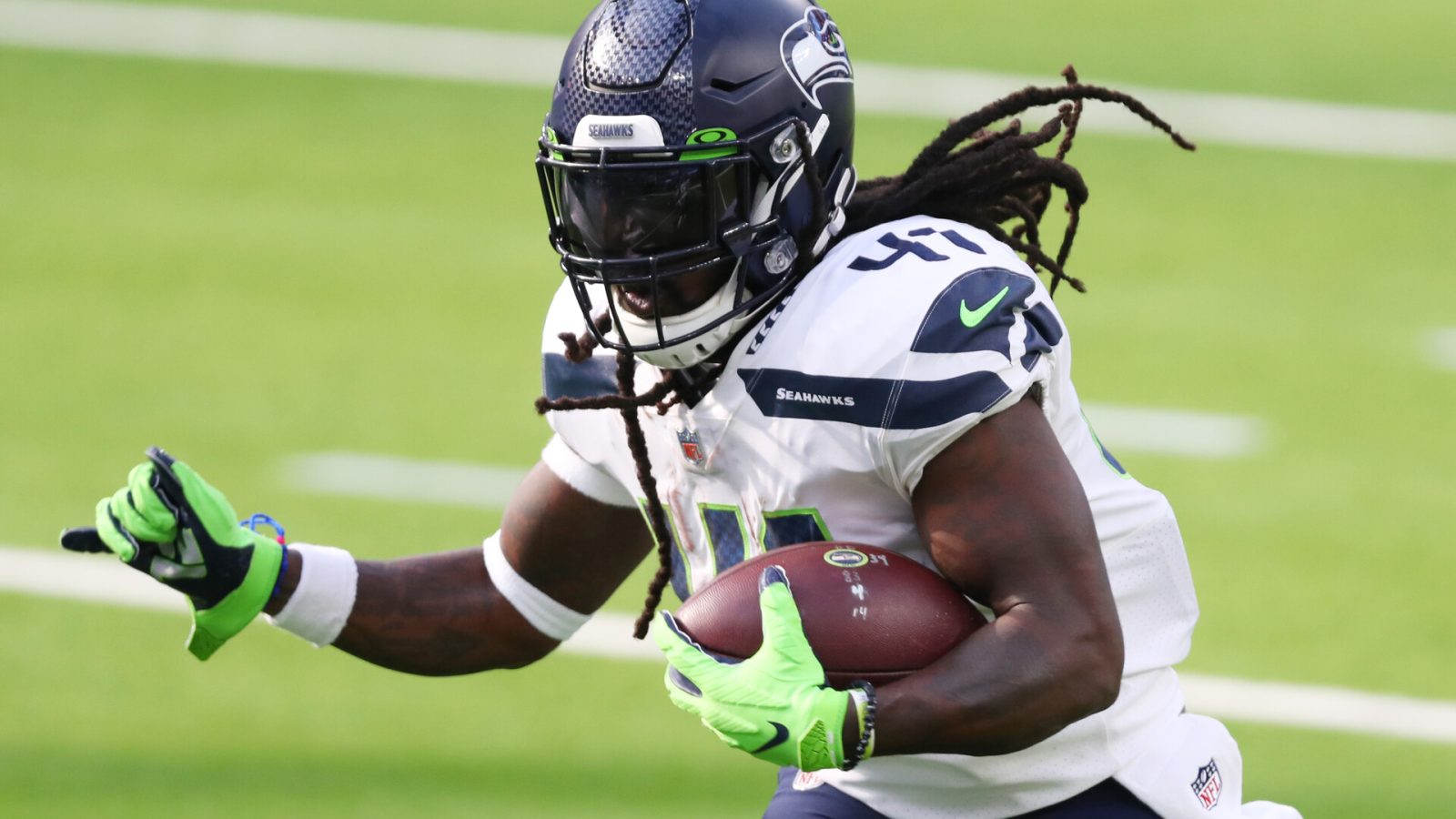 Seattle Seahawks running back #41 Alex Collins runs with the ball in a 2021 road game.